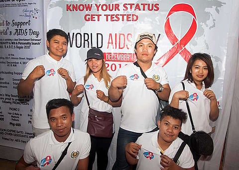 BAGUIO. HIV-Aids advocates show their shirts with the symbolic ribbon to advocate awareness of the disease. More than 9.4 million people do not know that they are living with Aids. (Photo by Jean Nicole Cortes)