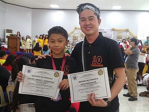 PANGASINAN. Vincent Jeremy Barraquias with coach Aquiles Bacallan at the 2019 National Schools Press Conference in Lingayen, Pangasinan. (Contributed photo)
