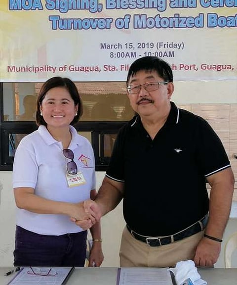 COLLABORATION. House of David Foundation Inc. Chairperson Terry David-Carlos and Guagua Mayor Dante Torres shake hands during the ceremonial agreement signing and turnover of a motorized boat on Friday. (Nicole Renee David)