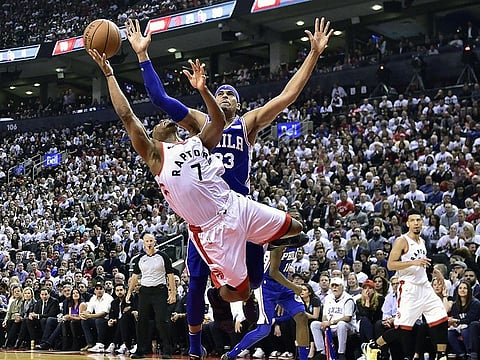 Toronto Raptors guard Kyle Lowry (7) draws a foul on Philadelphia 76ers forward Tobias Harris (33) as he drives to the net during second-half, second-round NBA basketball playoff action in Toronto, Monday, April 29, 2019. (AP)
