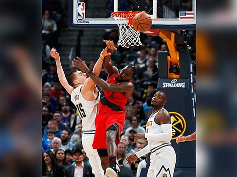 Denver Nuggets center Nikola Jokic, left, fights for control of a rebound with Portland Trail Blazers forward Al-Farouq Aminu during the first half of Game 2 of an NBA basketball second-round playoff series Wednesday, May 1, 2019, in Denver. (AP Photo)