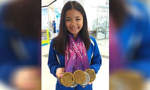 DAVAO. Dabawenya swimmer Lora Micah Amoguis, 13, shows the three gold medals, five silvers and one bronze she won in the recently concluded Arafura Games 2019 held in Darwin, Northern Territory, Australia after the Davao Sportswriters Association Forum held last Thursday, May 9, at The Annex of SM City Davao. (Marianne L. Saberon-Abalayan)