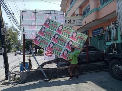 BACOLOD. Supporters of reelected Bacolod City Councilor Cindy Rojas remove tarpaulins in various areas of Bacolod. (Contributed photo)