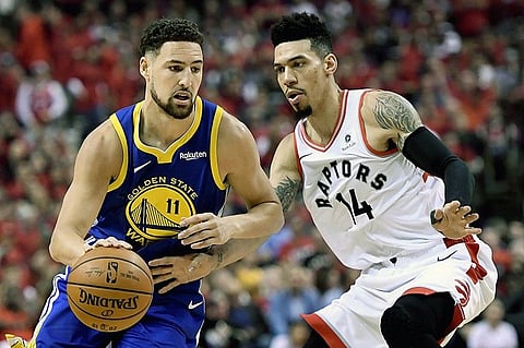 Toronto Raptors guard Danny Green (14) pressures Golden State Warriors guard Klay Thompson (11) as he drives down court during the first half of Game 2 of basketball's NBA Finals, Sunday, June 2, 2019, in Toronto. (AP)