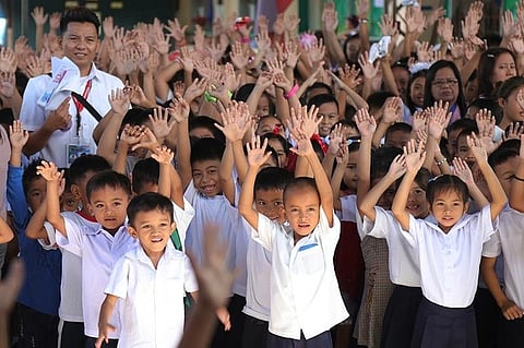 In this file photo, Grade 1 pupils raised their hands when their principal asked who was excited for the new school year during the “Welcome Back to School” program held at Sto. Niño Elementary School on Monday, June 3, 2019.