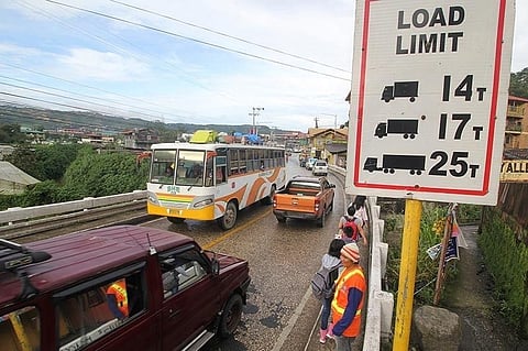 BAGUIO. Department of Public Works and Highways personnel monitor vehicles passing through Balili Bridge in Kilometer 6, La Trinidad, Benguet to make sure vehicles passing through do not exceed the carrying capacity. A steel plate was placed to cover a hole near the end of the bridge. (Jean Nicole Cortes)