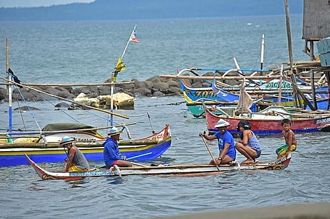 DAVAO. A group of fishermen rides a small boat as they head to their fishing boat docked few meters away from the seawall in Barangay 23-C Isla Verde, Davao City.