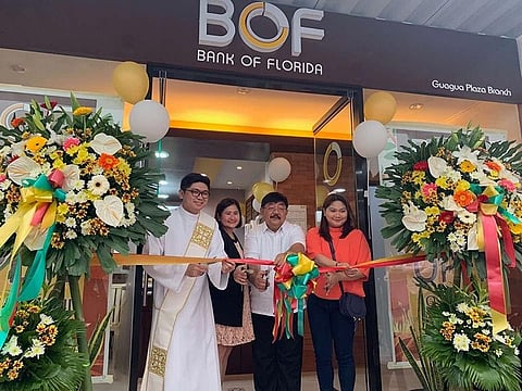 GUAGUA. Bank of Florida (BOF) president Teresa David-Carlos and Guagua Mayor Dante Torres cut the ribbon during the opening of BOF's Guagua branch. Joining them is lawyer Janina Lagman. (Contributed photo)