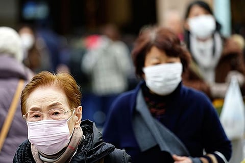 JAPAN. Pedestrians wear protective masks as they walk through a shopping district in Tokyo Thursday, January 16, 2020. Japan's government said Thursday a man treated for pneumonia after returning from China has tested positive for the new coronavirus identified as a possible cause of an outbreak in the Chinese city of Wuhan. (AP)