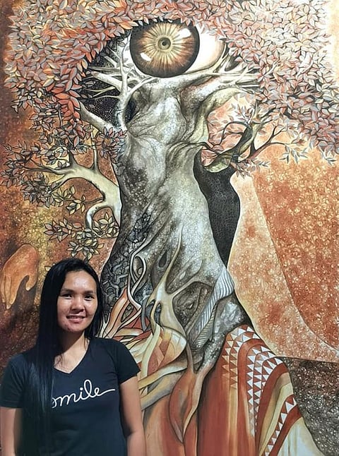 THE ARTIST AND HER ART. Salima Silagon Saway Agraan at home with one of her artworks. (Photo by Kublai P. Millan)