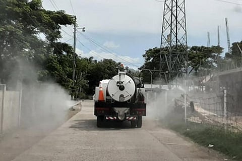 ZAMBOANGA. The City Government on Wednesday, March 26, uses the water tanker of the City Disaster Risk Reduction Management Office to disinfect the community where the patient confirmed with Covid-19 resides in the village of Sinunuc, Zamboanga City. (City Hall Information Office photo)