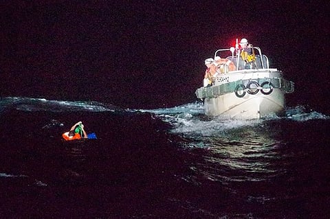JAPAN. In this photo released by the 10th Regional Japan Coast Guard Headquarters, a Filipino crewmember of a Panamanian cargo ship is rescued by Japanese Coast Guard members in the waters off the Amami Oshima, Japan Wednesday, September 2, 2020. (AP)