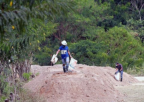 BARRICADE. Itogon residents, particularly those from the lower stream, are opposing the raising of Benguet Corp's TSF dam 2 by another seven meters, fearing that the tailing pond might breach and spill toxic mine waste, endangering lives and properties. (JJ Landingin)