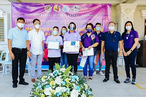 GIFT OF WATER. CSFWD General Manager Jorge Gumba and Mayor edwin Santiago join members of the women's sector during the kick-off of Women's Month in the City of San Fernando. (City of San Fernando Information Office)