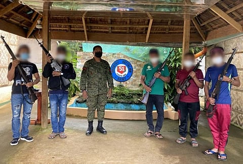 ZAMBOANGA. Five supporters of the Dawlah Islamiya-Maute Group surrender Thursday, May 27, to the Army's 51st Infantry Battalion (IB) in Dilausan village, Madalum, Lanao del Sur. A photo handout shows the surrenderers and the firearms they yielded in a photo session with Lieutenant Colonel Fernando Payapaya, 51IB commander. (SunStar Zamboanga)