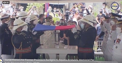 MANILA. In this screenshot taken from Malacañang video, military generals who served as pallbearers salute as honor guards hold the Philippine flag over the urn containing the cremated remains of former President Benigno Simeon C. Aquino III during the inurnment at the Manila Memorial Park on June 26, 2021. (State-owned RTVM video)