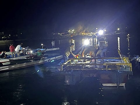 In this photo released by the National Search and Rescue Agency (BASARNAS), residents and members of the agency search for survivors after an overloaded ferry capsized off Indonesia's Sulawesi island, Monday, July 24, 2023. (BASARNAS via AP)
