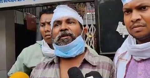 Journalist Kamal Shukla (centre) speaking to media persons after a mob attacked him.
