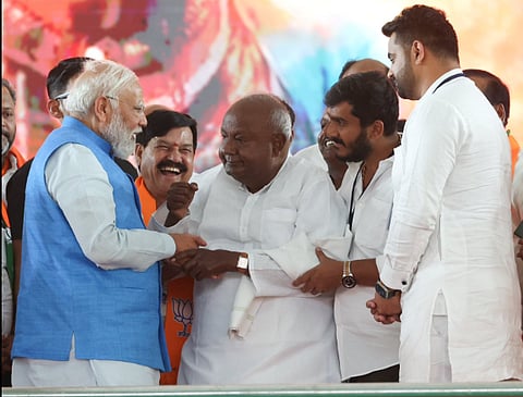 Prime Minister Narendra Modi with JD(S) Supremo and former PM H D Devegowda and his grandson Prajwal Revanna.