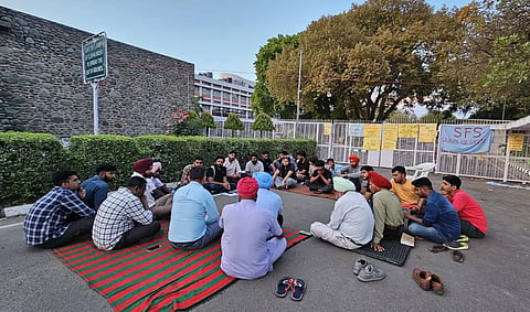 Students seated outside VC's office