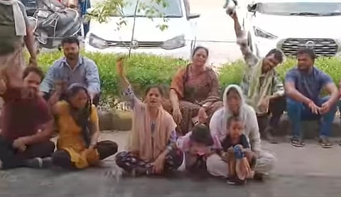 Dalit community members protesting outside the police station.