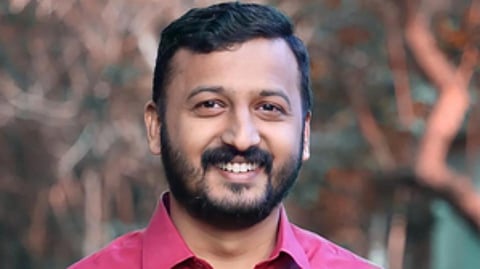 Image featuring Rahul Mamkootathil wearing a red shirt