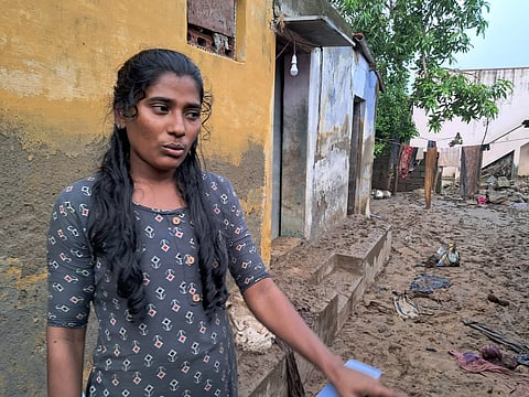 Maria, a resident of Gurus Kovil Street in Srivaikuntam, points to the havoc wreaked by floods at her home