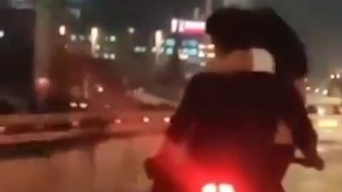 Screen grab from the video of the man and woman on the bike