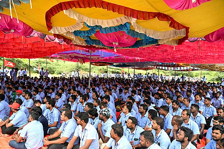 Workers' of Samsung Indian sit in a protest site under a colourful pandhal