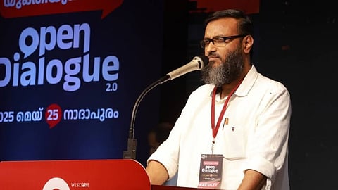 Image featuring TK Ashraf speaks at a podium during an event called "Open Dialogue 2.0.