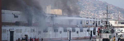 Smoke rises from a dock after explosions were heard at La Guaira port, Venezuela, Saturday, Jan. 3, 2026.