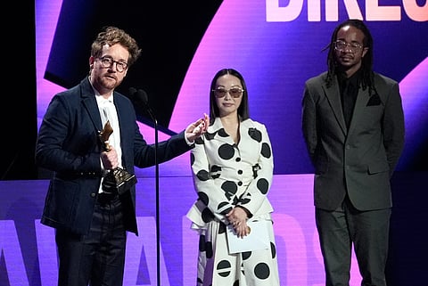 Clint Bentley accepts the award for best director for "Train Dreams" during the Film Independent Spirit Awards on Sunday, Feb. 15, 2026, at the Hollywood Palladium in Los Angeles. Lulu Wang looks on from right.