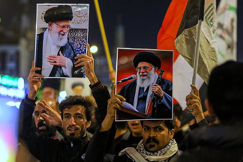 Iraqi Shiites hold pictures of Iranian Supreme Leader Ayatollah Ali Khamenei, who was killed by a U.S. airstrike in Tehran, during a symbolic funeral, in Najaf, Iraq, Sunday, March 1, 2026.