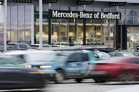 Cars drive by a Mercedes-Benz dealership on the Bedford Automile in Bedford, Ohio, Friday, Feb. 20, 2026.