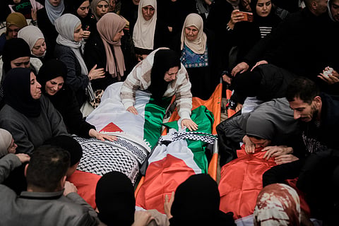 Palestinians mourn at the funeral of four members of the Odeh family who were killed in their car by Israeli security forces during an army operation in Tammun, West Bank, Sunday, March 15, 2026. (AP Photo/Majdi Mohammed)