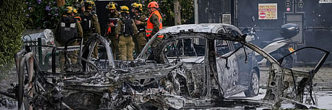 Israeli security forces inspect a site damaged during an Iranian missile strike in Tel Aviv, Israel, on March 15.