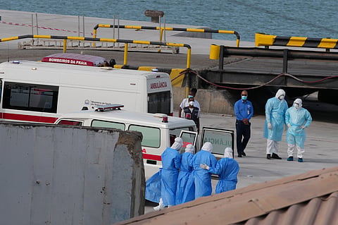 Health workers in protective gear evacuate patients from the MV Hondius cruise ship at a port in Praia, Cape Verde, Wednesday, May 6, 2026.