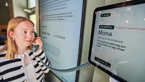 Hanna Petersson, a member of Andon Labs’ technical staff, uses a telephone handset to speak with Andon Café's AI agent 'Mona' in Stockholm, Sweden, Tuesday, May 5, 2026.
