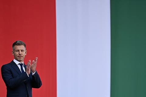 Hungarian Prime Minister Peter Magyar applauds in front of the Hungarian Parliament, after taking his oath of office in Budapest, Hungary, Saturday, May 9, 2026.