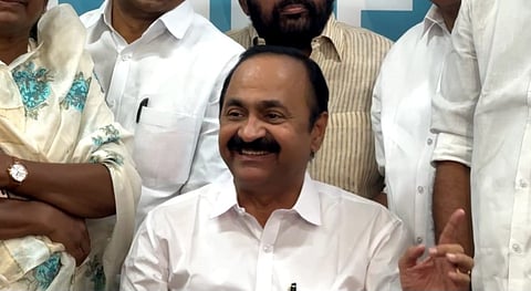 VD Satheesan smiles while seated among Congress leaders and party members after his selection as Kerala Chief Minister.