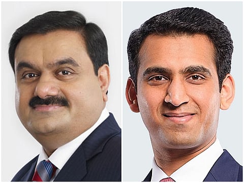 A side-by-side collage of two Indian businessmen. On the left is Gautam Adani, an older man with a mustache and striped tie. On the right is Sagar Adani, a younger man with short hair and a pink tie. Both wear professional suits against a plain background.