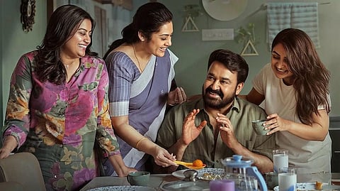 Ansiba, Meena, Mohanlal, Esther sit around a dining table in a poster from Drishyam 3