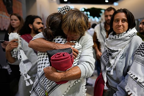 Activists from the Global Sumud Flotilla comfort each other upon their arrival at Istanbul Airport, in Istanbul, Turkey, Thursday, May 21, 2026.