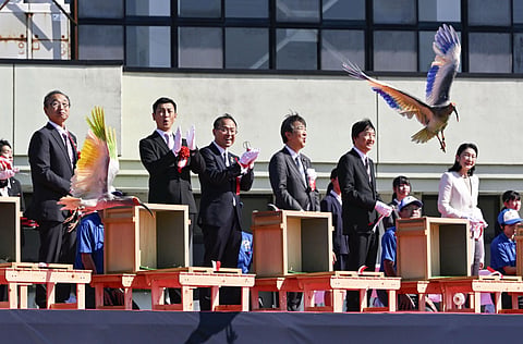 Japan's Crown Prince Akishino, second right, Crown Princess Kiko, right, and other officials watch a crested Ibis marked with painted wings released into wild during an event in Hakui, Japan, Sunday, May 31, 2026.