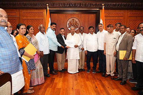 Karnataka State Backward Classes Commission Chairperson Madhusudan Naik submits the Karnataka Social and Educational Survey 2025 report to the then CM Siddaramaiah.