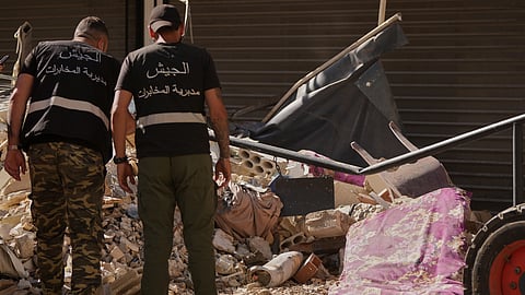 Lebanese intelligence officers look at an unexploded missile, centre, at the site where an Israeli airstrike hit a building in Dahiyeh, Beirut's southern suburb, Lebanon, Sunday, June 7, 2026.