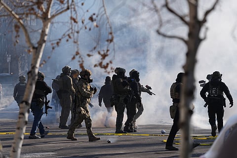 Federal immigration officers deploy tear gas at protesters after a shooting Jan. 24, 2026, in Minneapolis.
