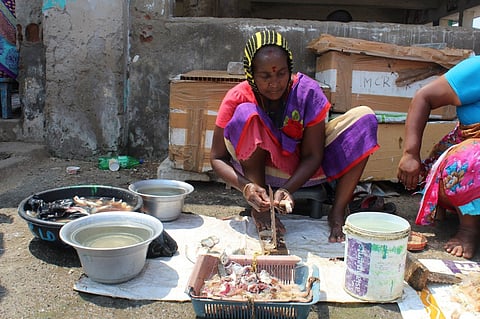 A woman vendor toils in the Chennai heat.