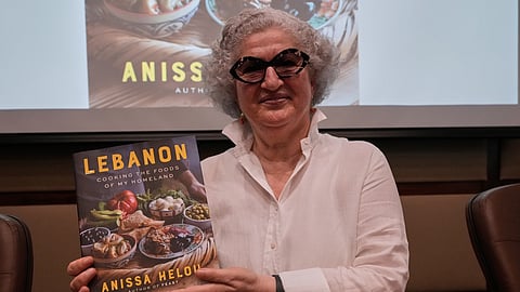 Anissa Helou, 74, one of the Middle East's most acclaimed cooks and food writers, holds her new book during a ceremony at the Lebanese Ministry of Tourism, in Beirut, Lebanon, Tuesday, June 23, 2026.