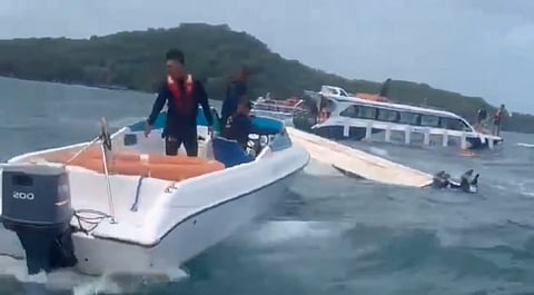Screengrab from a rescue video showing boats surrounding a partially submerged speedboat off Vietnam's Phu Quoc island as rescuers assist passengers in the water following the July 11 accident.